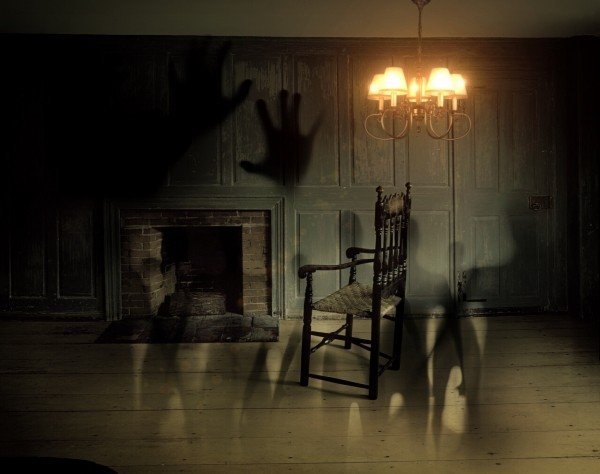 shadows-of-hands-and-humans-in-gloomy-room