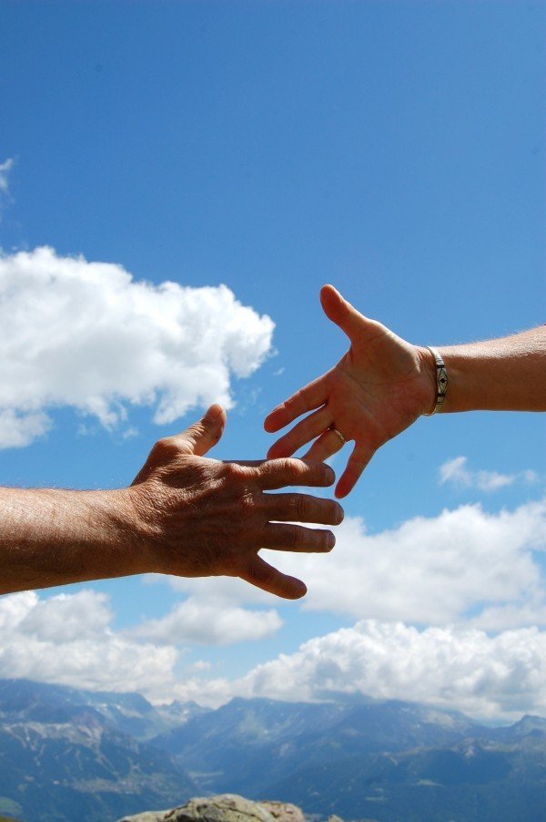 solidarity-sky-handshake-man-woman-clouds-blue