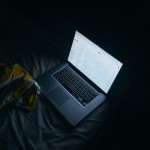 laptop-on-bed-in-dark-room